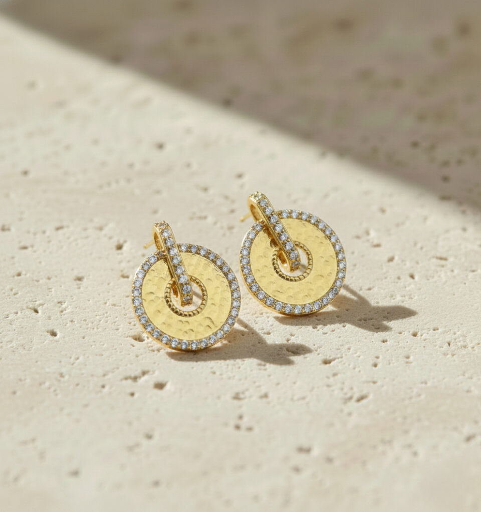 Luxury gold round earrings with hammered finish and crystal accents.