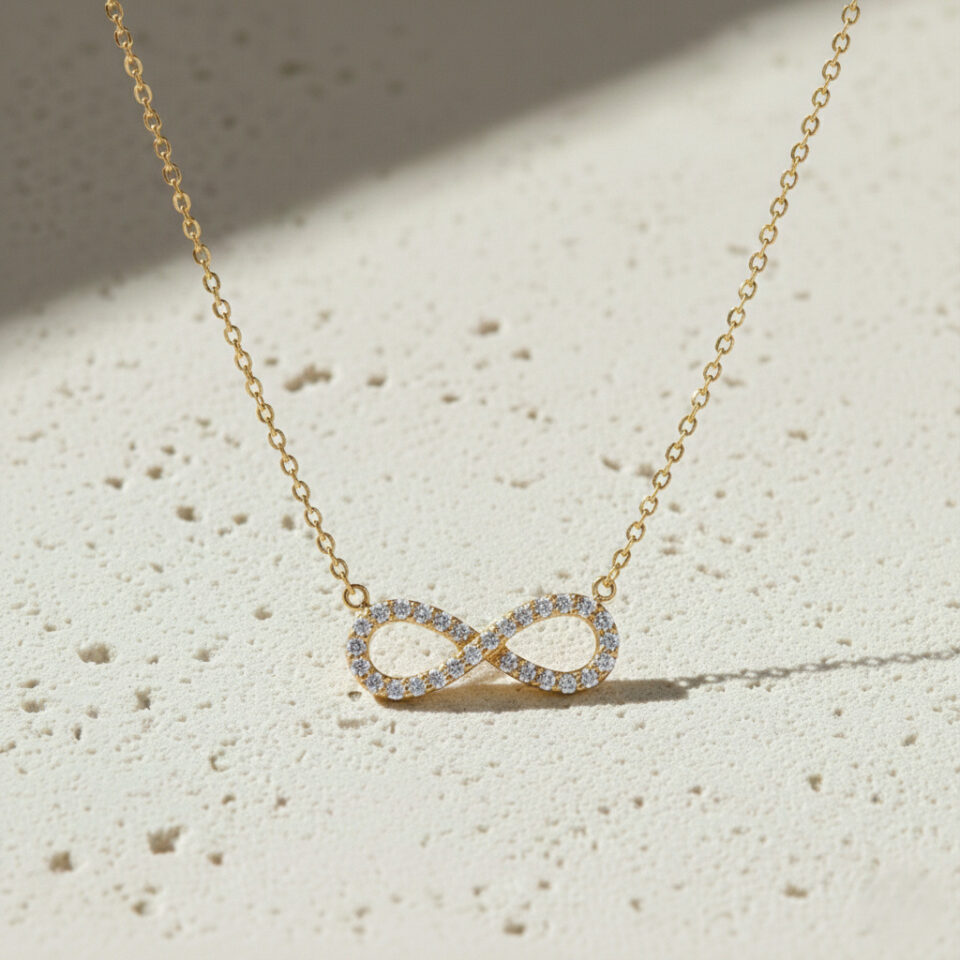 Infinity CZ gold pendant necklace with sparkling stones, handcrafted jewelry by Jaipur manufacturer