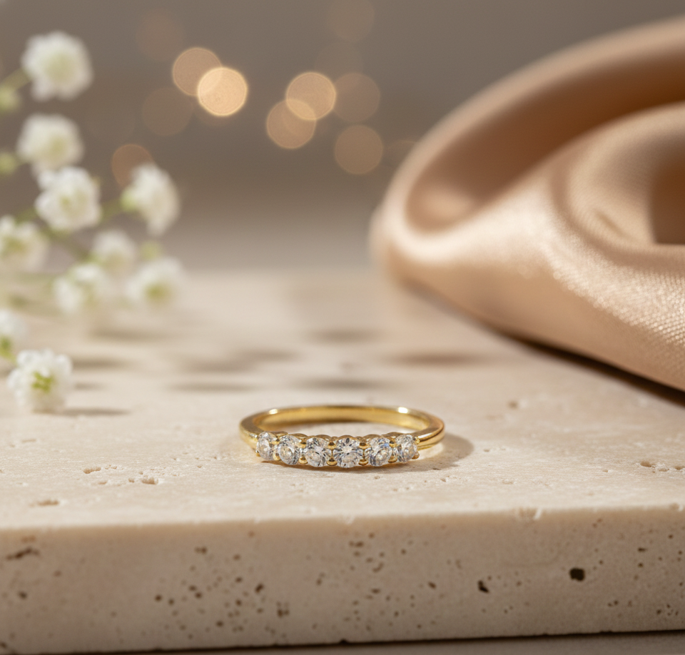 Elegant half eternity ring featuring round brilliant crystals set in a gold-plated band. The minimalist, timeless design makes it perfect for everyday wear, stacking, gifting, and bridal styling. High-quality shine with a premium finish.