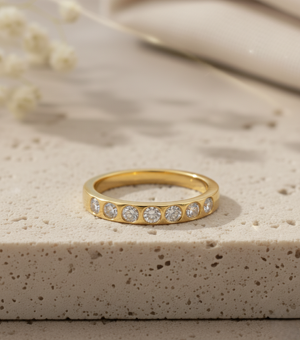 gold plated half eternity ring with seven bezel set cz stones, minimal design, crafted by leading jewelry manufacturer in jaipur