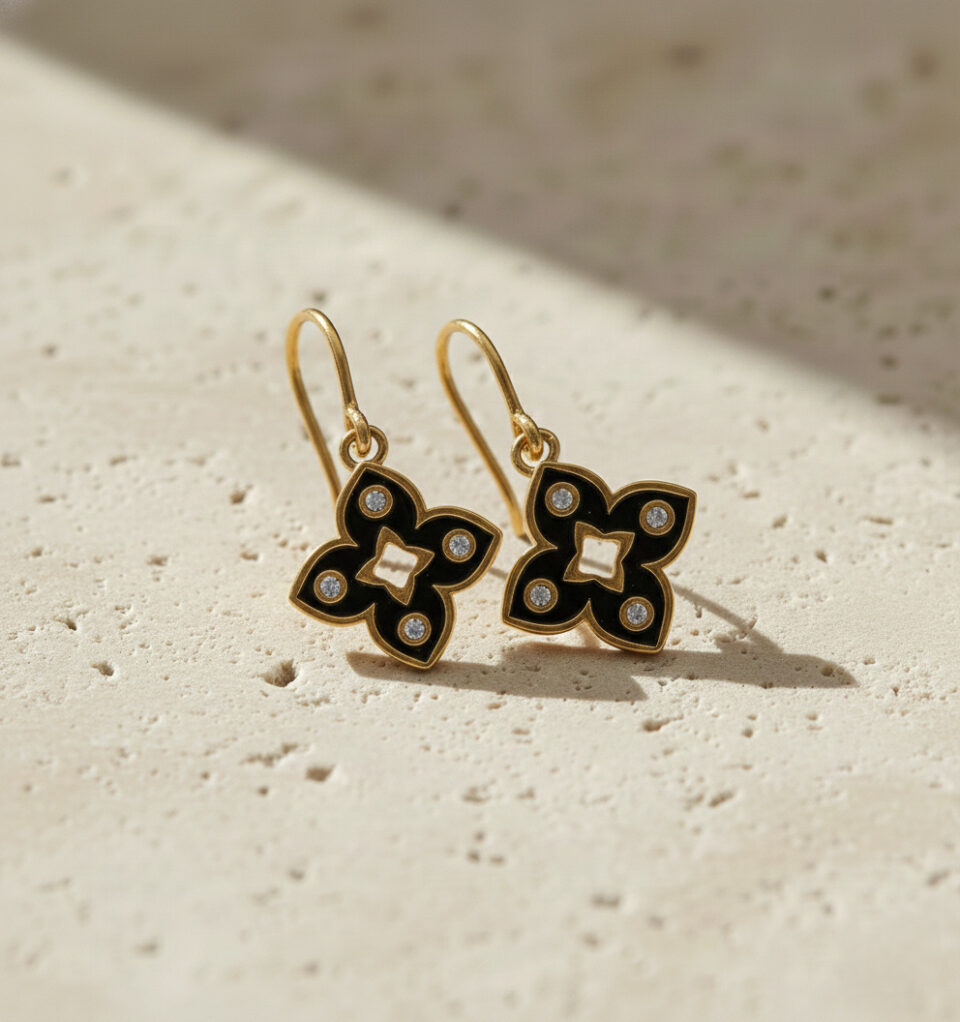 Gold plated black enamel floral earrings with CZ stones.