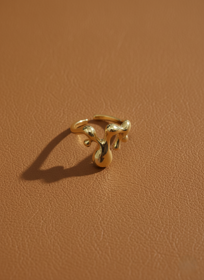 Sterling silver dripping ring with smooth liquid-inspired curves, artistic statement accessory