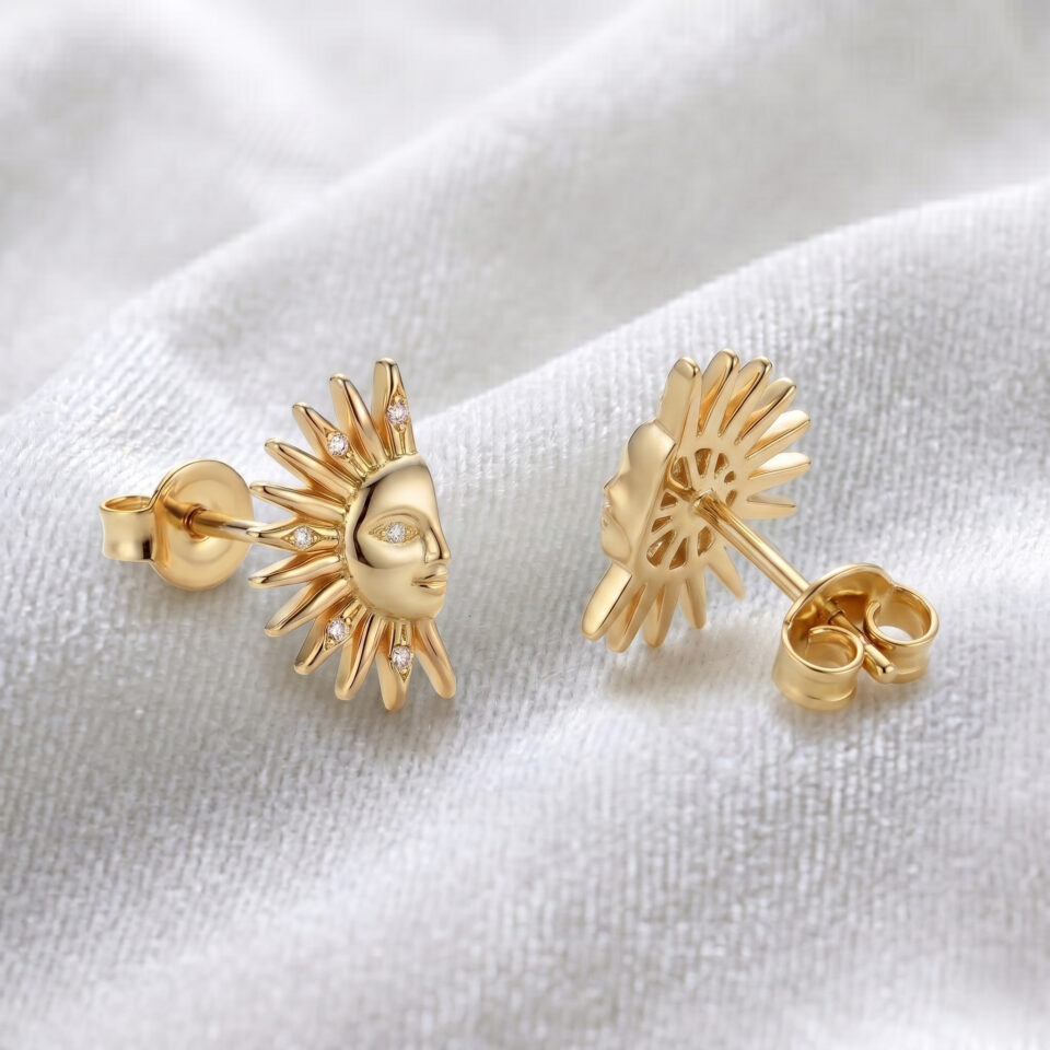 Gold sun face stud earrings with detailed design