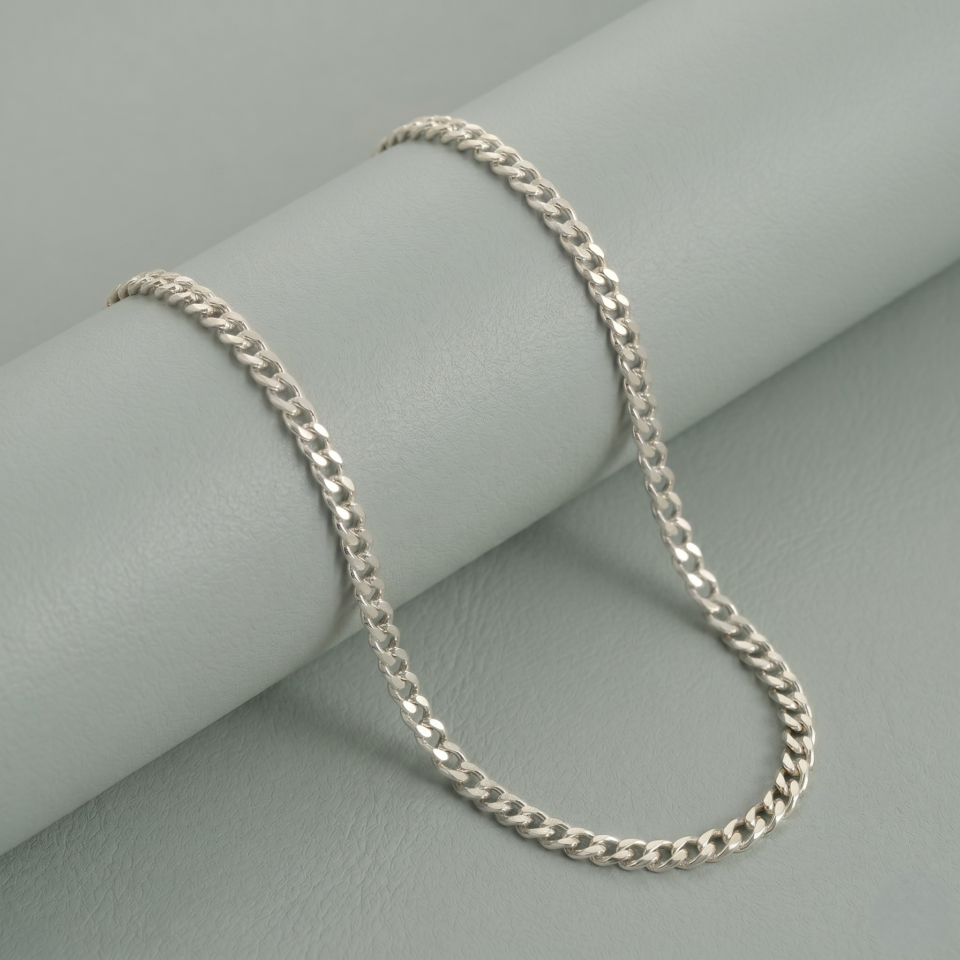 Gold plated curb chain necklace in sterling silver on soft display background.