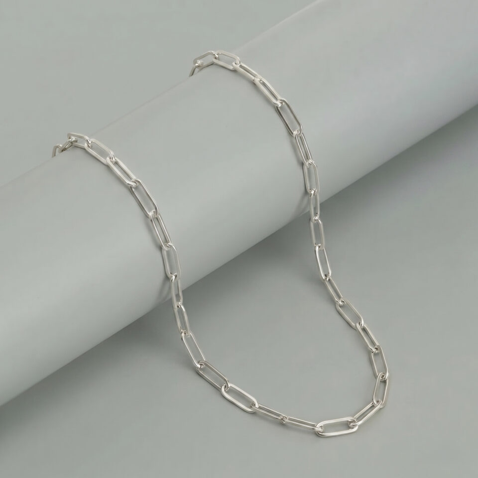 Modern elongated silver chain necklace crafted in sterling silver with smooth shine.