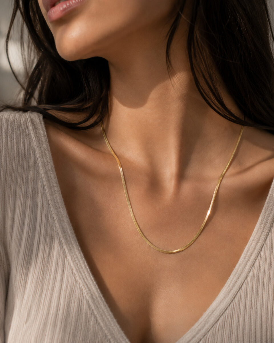 Smooth snake chain necklace with polished silver finish.