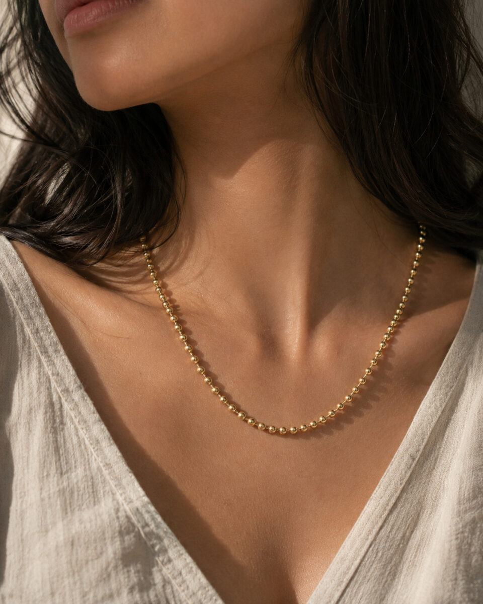 Minimal beaded necklace with smooth round bead detailing.